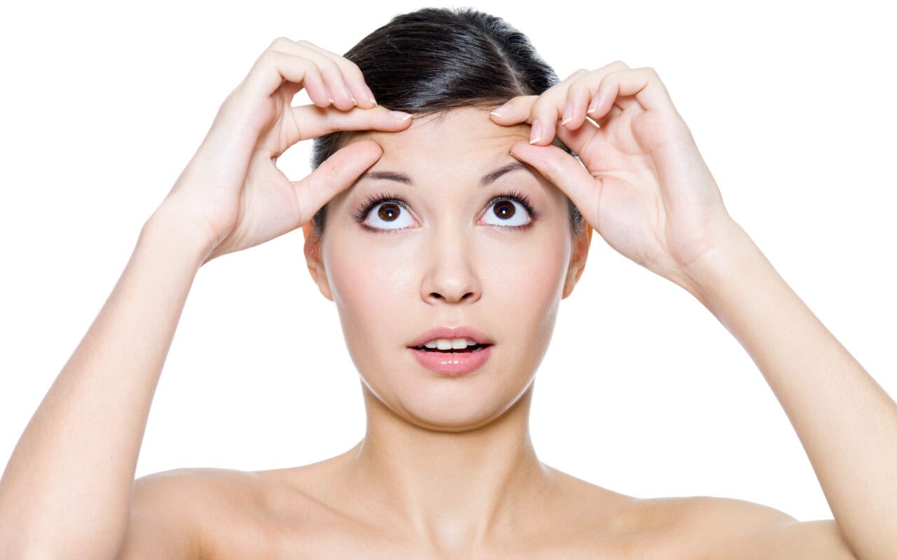 Female face with the wrinkles on her forehead